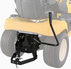 the front end of a yellow lawn mower with its wheels on it's side