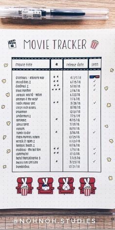 the movie tracker is shown on top of a notebook with markers and pens next to it