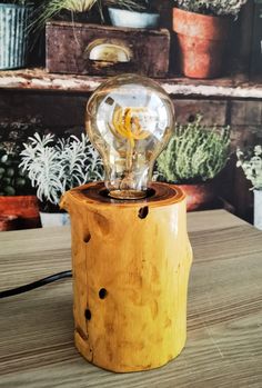 a light bulb sitting on top of a wooden table