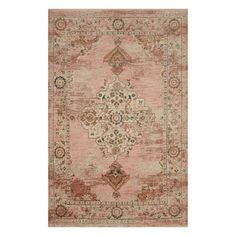 an antique style rug in pink and beige tones