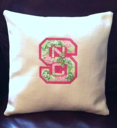 a pillow with the letter s embroidered on it