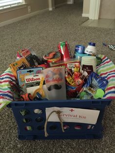 a blue basket filled with lots of items on top of a carpeted floor next to a door