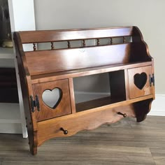 a wooden bench with two hearts cut out of it's sides on the floor