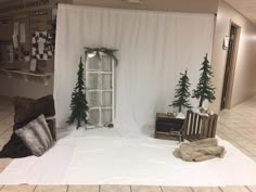 a room decorated for christmas with white curtains