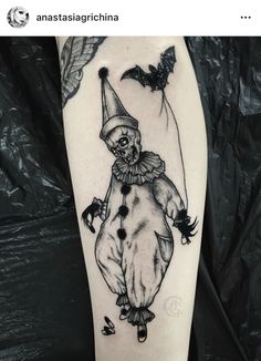 a black and white image of a clown on the leg, with bats flying around