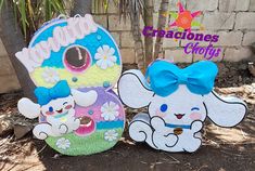 two wooden signs with cartoon animals on them, one is blue and the other is white