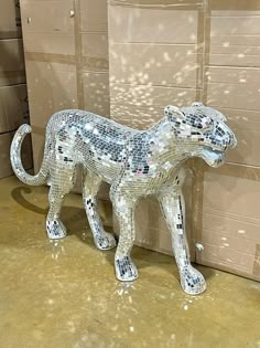 a sculpture of a cat made out of glass tiles