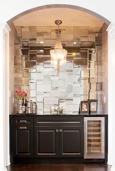 an instagramted photo of a bathroom with black cabinets and white tiles on the wall