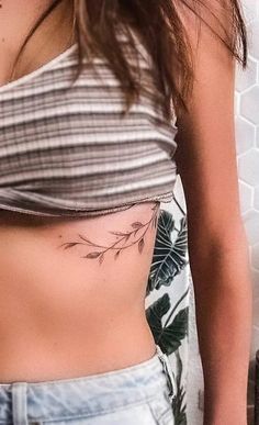 a woman with a flower tattoo on her stomach