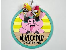 a pig welcome sign hanging on the wall