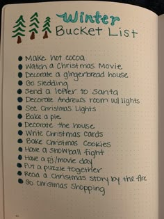 a christmas bucket list in a notebook with the words winter bucket list written on it