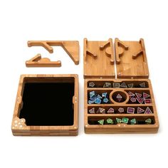 an open wooden box with dices and magnets in it on a white background