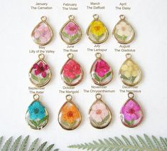 a bunch of different colored flowers in tear shaped pendants