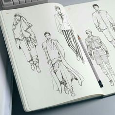 an open notebook with sketches of men's clothing on it and a pencil in the middle