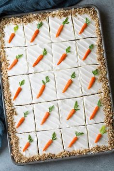 carrots are arranged on top of white frosting in the shape of small squares