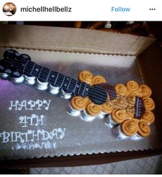 a guitar shaped cake with the words happy birthday written on it