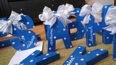 blue wooden letters decorated with white polka dots and bows