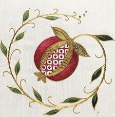 a close up of a piece of cloth with an apple and leaves design on it