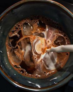 a glass bowl filled with liquid and ice