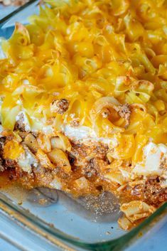 a casserole dish with noodles and cheese in it on a blue tablecloth