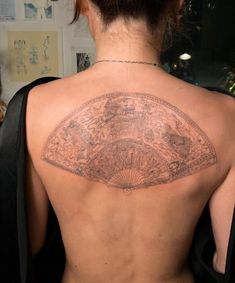 a woman with a tattoo on her back