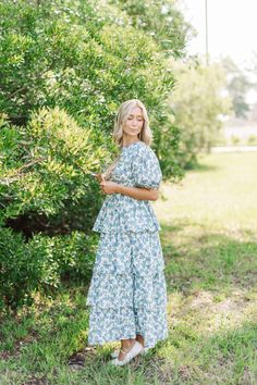 Long tiered dress in blue and green small floral print. It is lightweight, breathable material and closes with a button closure at the back. Designed by Aureum. Floral Dress Modest, Missionary Dresses, Mission Fits, Long Tiered Dress, Light Blue Floral Dress, Modest Floral Dress, Sunday Dresses, Floral Dresses With Sleeves, Church Fits