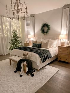 a bedroom decorated for christmas with white and green decor