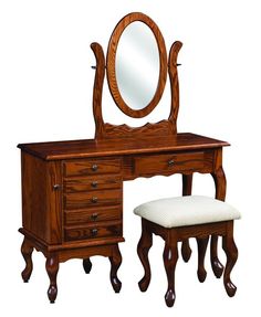 an antique wooden vanity with mirror and stool