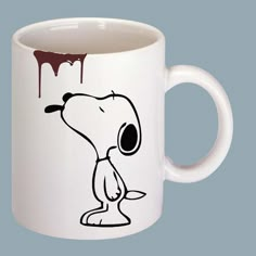 a white coffee mug with a cartoon dog on it's side and dripping paint