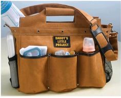 a diaper bag filled with baby's bottles and other personal care items sitting on top of a table