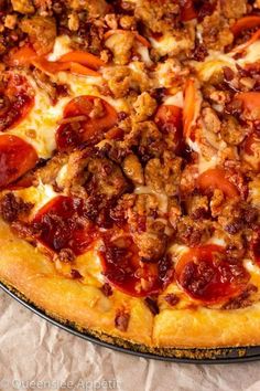 a pizza with sausage and tomatoes on it