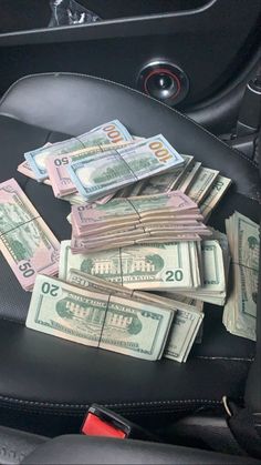 a bunch of money sitting in the back seat of a car