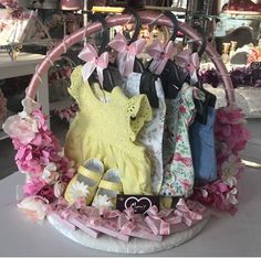 a basket filled with lots of baby clothes