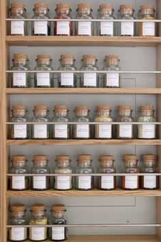 the shelves are filled with jars and spices