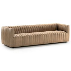 a beige couch sitting on top of a white floor