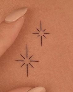 a woman's stomach with two small stars on the back of her belly, and one