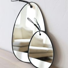 a mirror hanging on the wall next to a couch