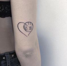 a woman's arm with a heart tattoo on the left side of her arm