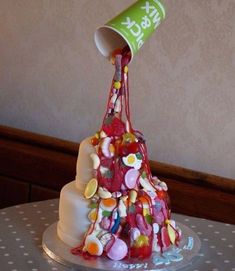 a cake that has been made to look like a tree with candy on it and is being poured into the cup