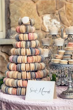 an assortment of macaroni and cheeses displayed on a table with a sign