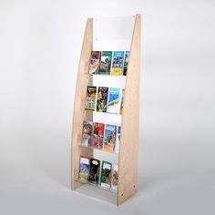 a wooden book shelf with several books on the top and bottom shelves that are open