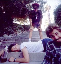 an open book with two men on the steps and one man standing on his head