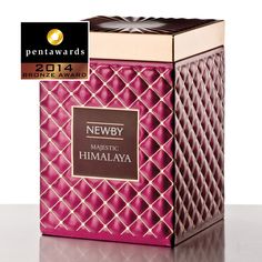 a pink and gold box with the words newby on it, in front of a white background