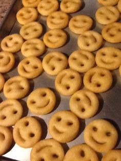 there are many doughnuts on the tray ready to be baked in the oven