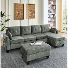 a living room with a sectional couch and ottoman