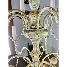 an old chandelier with candles in the background