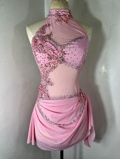 a mannequin is dressed in pink and has beading on the neckline