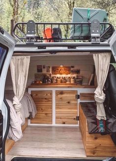 the back end of a van with its doors open and furniture in the cargo area