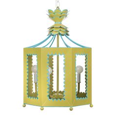 a yellow and blue birdcage hanging from a light fixture with scalloped edges