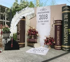 an outdoor display with books and flowers